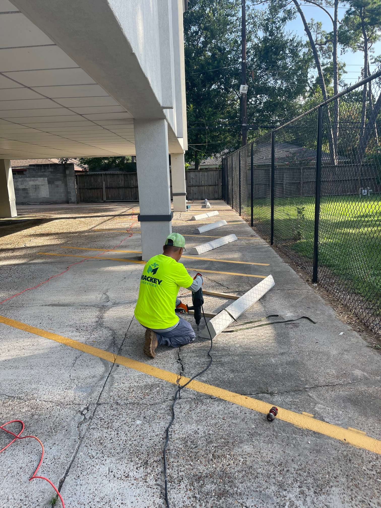 Mackey team member repairing a concrete parking stop